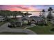 Scenic lakefront house at sunset, showcasing its manicured lawn and prime location at 29150 Beauclaire Dr, Tavares, FL 32778