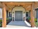 Charming covered entryway with wood accents, decorative planters, and a welcoming aesthetic at 29150 Beauclaire Dr, Tavares, FL 32778