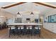 Modern kitchen with large island, pendant lighting, stainless steel appliances, and breakfast bar seating at 29150 Beauclaire Dr, Tavares, FL 32778