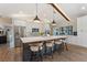 Modern kitchen with large island, pendant lighting, stainless steel appliances, and breakfast bar seating at 29150 Beauclaire Dr, Tavares, FL 32778