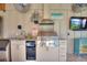 Outdoor kitchen complete with sink, grill, refrigerator and beverage center at 29150 Beauclaire Dr, Tavares, FL 32778
