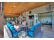 Covered patio boasts an outdoor kitchen, dining area, seating, and adjacent fitness room at 29150 Beauclaire Dr, Tavares, FL 32778