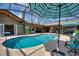 Screened-in pool with an outdoor kitchen, dining, and relaxing outdoor living at 29150 Beauclaire Dr, Tavares, FL 32778