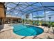 Screened in pool with an outdoor living area, dining and lush landscaping at 29150 Beauclaire Dr, Tavares, FL 32778