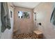 Walk-in shower features pebble stone flooring, tiled walls, a rain shower head, and a window at 29150 Beauclaire Dr, Tavares, FL 32778