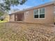 Spacious backyard with patio and mature trees providing ample shade at 30411 Gidran Ter, Mount Dora, FL 32757