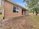Large backyard featuring mature trees and a covered patio at 30411 Gidran Ter, Mount Dora, FL 32757