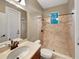 Cozy bathroom featuring a tiled shower, single vanity and plenty of natural light at 30411 Gidran Ter, Mount Dora, FL 32757
