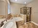 Bathroom featuring soaking tub, glass shower, and countertop sink at 30411 Gidran Ter, Mount Dora, FL 32757