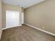 Bedroom featuring neutral color walls, carpet, and closet with double doors at 30411 Gidran Ter, Mount Dora, FL 32757
