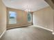 Bedroom featuring neutral color walls, carpet, and windows with backyard views at 30411 Gidran Ter, Mount Dora, FL 32757