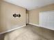 Bedroom featuring neutral color walls, carpet, TV mount, and a closet with double doors at 30411 Gidran Ter, Mount Dora, FL 32757