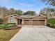 Charming single-story home with a three-car garage and well-manicured landscaping at 30411 Gidran Ter, Mount Dora, FL 32757