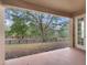 Covered patio with a view of the fenced backyard and mature trees at 30411 Gidran Ter, Mount Dora, FL 32757