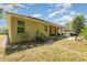 Green backyard with a covered patio, a modern koi pond, and lawn area at 31 Abacus Ave, Ormond Beach, FL 32174