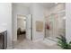 Bathroom featuring a glass-enclosed shower with tiled walls, next to an open door leading to bedroom at 31 Abacus Ave, Ormond Beach, FL 32174