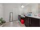 Bathroom with double vanity, tiled floors, and ample storage space, including a red stool at 31 Abacus Ave, Ormond Beach, FL 32174