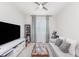 Cozy living room featuring tiled floors, ceiling fan and a large-screen TV at 31 Abacus Ave, Ormond Beach, FL 32174