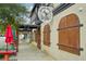 Charming storefront with a unique architectural design, vintage doors, and colorful umbrellas at 33432 Seattle Slew Dr, Sorrento, FL 32776