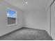 Clean bedroom featuring carpet, a window, and closet at 33448 Seattle Slew Dr, Sorrento, FL 32776