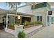 Exterior of building with stone accents, a covered patio, and lush foliage at 33448 Seattle Slew Dr, Sorrento, FL 32776