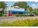 Street view of a charming building with a blue awning and red telephone box at 33448 Seattle Slew Dr, Sorrento, FL 32776