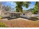 Rear view of home showing screened in porch and backyard at 4366 Roanne Dr, Orlando, FL 32817