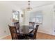 Bright dining room features a window, chandelier, and dining table with seating at 4366 Roanne Dr, Orlando, FL 32817