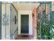 Close-up of the home's front door, surrounded by decorative ironwork and brick accents at 4366 Roanne Dr, Orlando, FL 32817