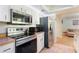 Bright kitchen with stainless steel appliances, wood countertops, and a view into the living area at 4366 Roanne Dr, Orlando, FL 32817