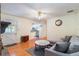 Living area with a decorative fireplace, laminate flooring, and access to kitchen at 4366 Roanne Dr, Orlando, FL 32817