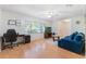 Bright living room featuring a ceiling fan, wood laminate flooring, and natural light at 4366 Roanne Dr, Orlando, FL 32817