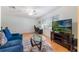 Cozy living space with laminate floors, a comfortable couch, and an entertainment center at 4366 Roanne Dr, Orlando, FL 32817