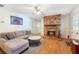 Inviting living room with a brick fireplace and wood laminate flooring at 4366 Roanne Dr, Orlando, FL 32817