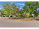 Street view of the home showing beautiful trees and landscaping at 4366 Roanne Dr, Orlando, FL 32817