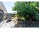Landscaped backyard with a brick patio and mature trees, offering shade and privacy at 458 Cadenza Dr, Orlando, FL 32807