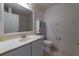 Bathroom featuring a vanity with storage, toilet, and enclosed shower at 458 Cadenza Dr, Orlando, FL 32807