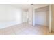 Clean bedroom with white walls, tile floors, and closet at 458 Cadenza Dr, Orlando, FL 32807