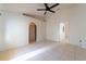 Bright bedroom with tile floors, ceiling fan, arched doorways, and fresh paint at 458 Cadenza Dr, Orlando, FL 32807