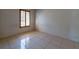 Cozy bedroom with neutral walls, tile flooring, and wood-shuttered window at 458 Cadenza Dr, Orlando, FL 32807