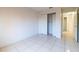 Clean bedroom with tile floors, closet, and access to the hallway at 458 Cadenza Dr, Orlando, FL 32807