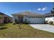 Charming single-story home with a well-manicured lawn and attached two-car garage at 458 Cadenza Dr, Orlando, FL 32807
