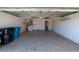 Spacious two-car garage with tile flooring and plenty of room for storage, laundry machines, and other utilities at 458 Cadenza Dr, Orlando, FL 32807