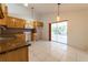 Eat-in kitchen with granite countertops, wood cabinets, and sliding door to lanai at 458 Cadenza Dr, Orlando, FL 32807