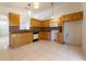 Spacious kitchen with wood cabinets, granite countertops, and mosaic tile backsplash at 458 Cadenza Dr, Orlando, FL 32807