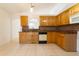 Well-lit kitchen with light wood cabinetry, granite counters, tile backsplash, and tile floors at 458 Cadenza Dr, Orlando, FL 32807