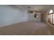 Spacious living room featuring tile flooring, arched doorways, and a ceiling fan at 458 Cadenza Dr, Orlando, FL 32807