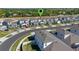 An aerial view captures a neighborhood with modern homes and meticulously manicured lawns, creating a serene setting at 4630 Cragmere Loop, Clermont, FL 34711