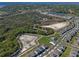Aerial view of community showcasing natural landscaping and walking trails, with a pool and modern residential development at 4630 Cragmere Loop, Clermont, FL 34711