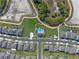 A bird's eye view features a community pool and park, surrounded by modern homes and well-planned streets at 4630 Cragmere Loop, Clermont, FL 34711